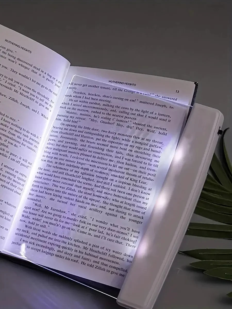 Book with a light illuminating the text on a white background